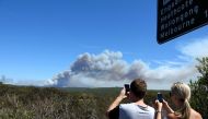 Onlookers watch as a bushfire burns in the Royal National Park, south of Sydney, New South Wales, Australia, 20 January 2018. EPA/BEN RUSHTON