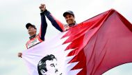 Qatari Rally Driver Nasser Saleh Al Attiyah (right) celebrating with Qatar’s flag after claiming the runner-up spot of the 40th Dakar Rally, held in Peru, Bolivia and Argentina, yesterday.