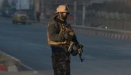 An Afghan security forces keeps watch near the Intercontinental Hotel following an attack in Kabul on January 21, 2018. / AFP / SHAH MARAI