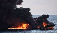 This handout file picture from the Transport Ministry of China taken and released on January 14, 2018 shows smoke and flames coming from the burning oil tanker 