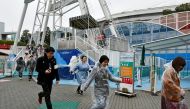 People at a missile evacuation drill at an amusement park near Tokyo Dome stadium in Tokyo, Japan, 22 January 2018. EPA/FRANCK ROBICHON