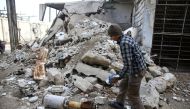 A man is seen near the remains of a rocket in Douma, Eastern Ghouta in Damascus, Syria January 22, 2018. REUTERS/Bassam Khabieh