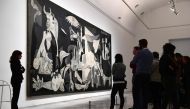 Visitors look at Guernica of Spanish artist Pablo Picasso at Reina Sofia museum in Madrid on March 24, 2017 (AFP / Pierre-Philippe Marcou) 