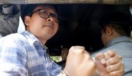Detained Reuters journalist Wa Lone is escorted by police for a court hearing in Yangon, Myanmar January 23, 2018. REUTERS/Stringer 