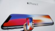 An attendee holds a new iPhone X during a presentation for the media in Beijing, China October 31, 2017. REUTERS/Thomas Peter