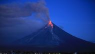 Lava spews from the Mayon volcano as it continues to erupt, seen from Legazpi City in Albay province, south of Manila early on January 23, 2018.  AFP / CHARISM SAYAT