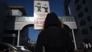This picture taken on January 17, 2018, shows a woman walking at Beihang University in Beijing. AFP / Wang Zhao 