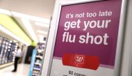File photo of a sign advertising flu shots is displayed at a Walgreens phramacy in San Francisco, California, January 22, 2018.  / AFP / GETTY IMAGES NORTH AMERICA / JUSTIN SULLIVAN