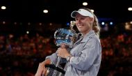  Denmark's Caroline Wozniacki celebrates with the trophy after winning the final against Romania's Simona Halep. REUTERS/Issei Kato