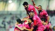 Al Rayyan players celebrate after scoring against Al Duhail during their QNB Stars League match against Al Duhai at Al Duhail Stadium yesterday. The thrilling encounter ended in a three-all draw.