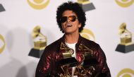 Singer Bruno Mars poses in the press room with his Grammy trophies during the 60th Annual Grammy Awards on January 28, 2018, in New York. AFP / Don EMMERT
