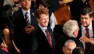 Newly elected Massachusetts Democratic Representative Joseph Kennedy III (C) smiles as he joins the 113th Congress in the Capitol in Washington January 3, 2013.  REUTERS/Kevin Lamarque