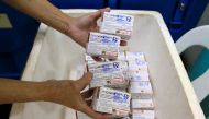 A health worker shows unused packs of anti-dengue vaccine Dengvaxia before returning it inside a freezer for storage at the Manila Health Department in Sta Cruz, metro Manila, Philippines December 5, 2017. Reuters/Romeo Ranoco