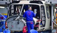 Employees of Leonardo Helicopters company work at a factory on January 30, 2018 in Vergiate, near Milan.  AFP / Marco Bertorello