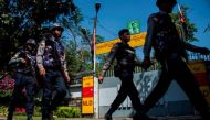 File photo of Police officers patrol in front of the residence of Myanmar's leader Aung San Suu Kyi in Yangon on February 1, 2018, after a petrol bomb was hurled into the compound. AFP / YE AUNG THU 