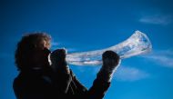 Terje Lsungset, the founder and artistic director of the Ice Music Festival, tests a musical instrument made of ice outside his workshop ahead of the festival on February 2, 2018 in the small mountain village of Finse in the municipality of Ulvik in south