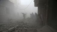 Syrian flee their homes following an airstrike in the rebel-held besieged town of Arbin, in the eastern Ghouta region on the outskirts of the capital Damascus on February 2, 2018. / AFP / ABDULMONAM EASSA