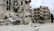 Members of civil defense carry out a search and rescue operation after an airstrike hits the city center of Idlib, Syria on February 5, 2018. Ahmet Rahhal - Anadolu
