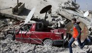 A man is seen running after an air raid in the besieged town of Douma in eastern Ghouta in Damascus, Syria, February 6, 2018. Reuters/ Bassam Khabieh