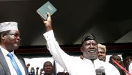 Kenyan opposition leader Raila Odinga of the National Super Alliance (NASA) holds a bible as he takes a symbolic presidential oath of office in Nairobi, Kenya January 30, 2018. Reuters/Baz Ratne