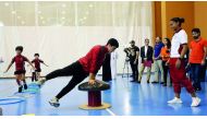 A Qatari gymnast demonstrates his skills to schoolchildren during last year’s National Sport Day in this file photo. INSET: Young boxers show off their skills during the 2017 National Sport Day. 