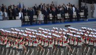 In this file photo taken on July 14, 2017 (FromL) French Defence Minister Florence Parly, French Prime Minister Edouard Philippe, US First Lady Melania Trump, US President Donald Trump, French President Emmanuel Macron and his wife Brigitte Macron, French