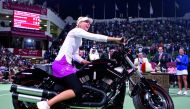 Russia’s Maria Sharapova sits on a motorcycle after defeating compatriot Vera Zvonareva in the final of the Qatar Open tournament in Doha in this 2008 file picture.