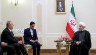 A handout picture provided by the Iranian presidency official website on February 7, 2018 shows President Hassan Rouhani (R) meeting with Turkish Foreign Minister Mevlut Cavusoglu (L) in the capital in Tehran. AFP PHOTO / HO / IRANIAN PRESIDENCY