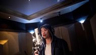 This picture taken on February 5, 2018 shows Shanghai rapper Naggy singing in his studio in Shanghai. AFP / Johannes Eisele 