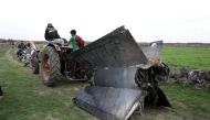 A tractor pulls a part of a missilein Quneitra, Syria February 10, 2018 REUTERS/Alaa al Faqir
