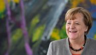 German Chancellor Angela Merkel walks out of her office to meet the President of the German Horticultural Association in the chancellery in Berlin, Germany, February 9, 2018. AFP / John MACDOUGALL
