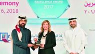 Rashid bin Ali Al Mansoori (left), CEO of QSE giving away the award to an official from Aamal Company, as Abdul Aziz Al Emadi, Director, Listing Department of QSE, looks on, at the 3rd Annual IR Excellence Program, recently.