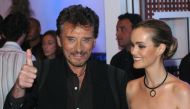 (FILES) In this file photo taken on October 02, 2003 French rock singer Johnny Hallyday (L) poses with his wife Laetitia Boudou.  AFP / JEAN AYISSI