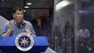 File photo of Philippine President Rodrigo Duterte delivering his speech to overseas Filipina workers (OFW) that arrived in Manila from Kuwait are at the Manila International Airport on February 13, 2018.  / AFP / NOEL CELIS
