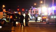 Police vehicles block the road to Marjory Stoneman Douglas High School in Parkland, Florida, following a shooting that killed 17 people on February 14, 2018 in Parkland, Florida. AFP / Gaston De Cardenas