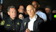 Florida Governor Rick Scott speaks to the media as he visits Marjory Stoneman Douglas High School following a shooting that killed 17 people on February 14, 2018 in Parkland, Florida. / AFP / Gaston De Cardenas
 