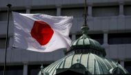 File photo of a Japanese flag fluttering atop the Bank of Japan building in Tokyo May 22, 2015. REUTERS/Toru Hanai