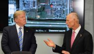 US President Donald Trump (L) speaks with Florida governor Rick Scott (R) while visiting first responders at Broward County Sheriff's Office in Pompano Beach, Florida, on February 16, 2018, three days after a mass shooting that claimed 17 lives at a nearb