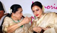 Indian Legendary Bollywood playback singer Asha Bhosle (L) and actress Rekha (R) talk during the fifth edition of 'Yash Chopra National Memorial Awards 2018' in Mumbai late on February 16, 2018. / AFP / - 