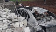 A wrecked vehicle is seen after an airstrike Hazzano town of Idlib, Syria on February 17, 2018. Ahmet Hatib - Anadolu
