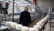 An employee of 'Garcia Baquero' cheese manufacturer works at the production line of the company's factory in Alcazar de San Juan on February 15, 2018. AFP / Benjamin Cremel 