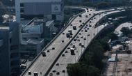 Motorists drive on an elevated highway in Singapore on February 19, 2018. Singapore will impose a carbon tax from next year to cut greenhouse gas emissions and make companies competitive as global agreements on climate change take effect, the government s