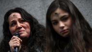 Lourdes Barraza, (L) wife of d etained immigrant Fernando Barraza, fights back tears as she speaks during a Valentine's Day demonstration outside of the San Francisco office of the Immigration and Cutsoms Enforcement (ICE) on February 14, 2018 in San Fran