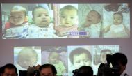 File photo of surrogate babies that Thai police suspect were fathered by a Japanese businessman who has fled from Thailand are shown on a screen during a news conference at the headquarters of the Royal Thai Police in Bangkok August 12, 2014. REUTERS/Athi