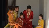 Canadian Prime Minister Justin Trudeau (2nd R) and his wife Sophie Gregoire Trudeau (2nd L) sit with their daughter Ella-Grace (R), and their sons Xavier (3rd L) and Hadrien (L) as they try out a ceremonial spinning wheel during their visit to Gandhi Ashr