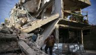 A person inspects damaged building in the besieged town of Douma, Eastern Ghouta, Damascus, Syria February 20, 2018. REUTERS/Bassam Khabieh