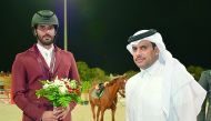 Qatari rider Mubarak Yousuf Al Rumaihi poses for a photograph with Qatar Equestrian Federation (QEF) President Hamad bin Abdulrahman Al Attiyah during the presentation ceremony. 
