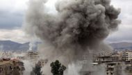 Smoke billows following Syrian government bombardments on Kafr Batna, in the besieged Eastern Ghouta region on the outskirts of the capital Damascus on February 22, 2018. / AFP / AMER ALMOHIBANY 