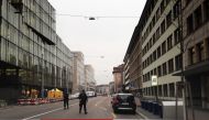 Police officials gather at the scene of a shooting outside a branch of UBS bank in Zurich on February 23, 2018. Two people were shot dead in central Zurich, police said, as media reported numerous shots had been fired in what appeared to have been a priva