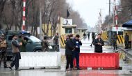Afghan security personnel stand guard near the site of a suicide bombing at Shash Darak in kabul on February 24, 2018. AFP / WAKIL KOHSAR
